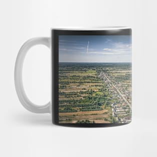 Aerial view of village surrounded by agricultural fields Mug